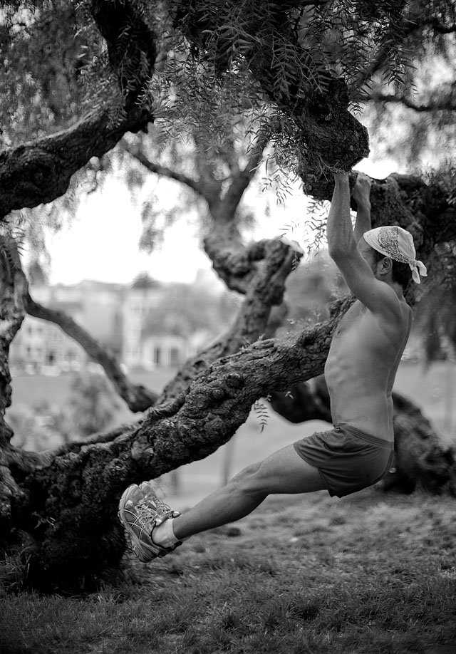 A fanatic runner performs a few athletic routines in a park in San Francisco.  