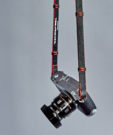 125cm x 15mm x 3mm Black Calfskin Camera Strap with stubs and orange edges. Inscription on the inside, "Always Wear A Camera".