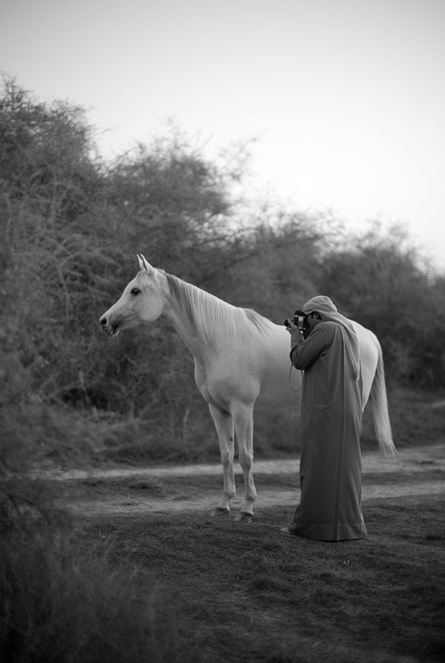 Khalid Al Thani photographing a horse in the low sunset light with a Visoflex lens on the Leica M9