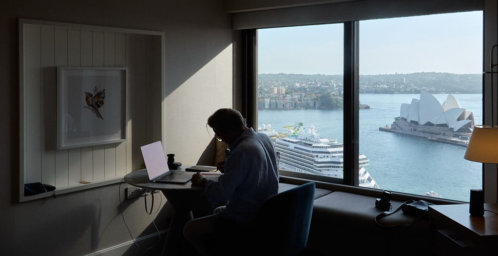 Thorsten Overgaard working in Sydney with a view to Jørn Utzon's Sydney Opera House and ther Carnival Splendor cruise ship that just arrived in the morning. Leica D-Lux 8. 