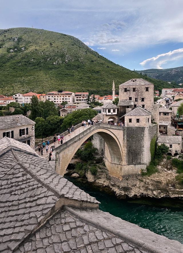 The famoThe view from our choice of coffee place: The famous UNESCO-designated Old Bridge in Mostar, located in the Old City of Mostar, Bosnia and Herzegovina, dates back to 1557. However, it tragically collapsed in 1993 during the war. The discussions regarding who caused its collapse and how it happened have yet to provide a definitive answer. Nonetheless, the bridge was rebuilt, and in the aftermath, it has been recognized as a symbol of the reunion of people on both sides. iPhone photo. © Thorsten Overgaard.us UNESCO-designated Old Bridge in Mostar, located in the Old City of Mostar, Bosnia and Herzegovina, dates back to 1557. However, it tragically collapsed in 1993 during the war. The discussions regarding who caused its collapse and how it happened have yet to provide a definitive answer. Nonetheless, the bridge was rebuilt, and in the aftermath, it has been recognized as a symbol of the reunion of people on both sides. iPhone photo. © Thorsten Overgaard.