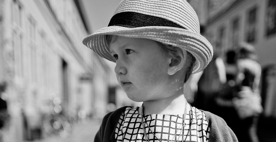 Young lady attending a wedding in Aarhus, Denmark. Leica Q with Leica 28mm Summilux-Q ASPH f/1.7. (800 ISO, 1/6400, f/1.7 with B+W 3-stop ND filter. Converted to monochrom in Lightroom from the DNG file). 
© Thorsten Overgaard.