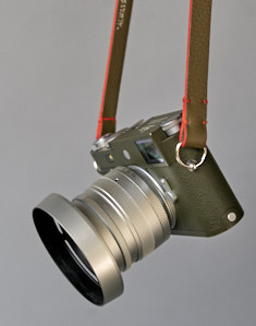 145cm x 15mm x 3mm Safari Green Calfskin Camera Strap with orange edges. Inscription on the inside, "Always Wear A Camera".