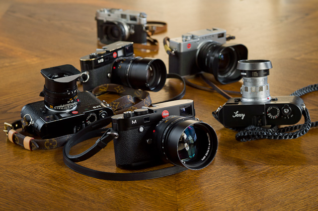 Some of the film and digital Leica cameras I've been using. Leica M240, Leica M9, Leica M Monochrom, Leica Digilux 2, Leica M4. 
