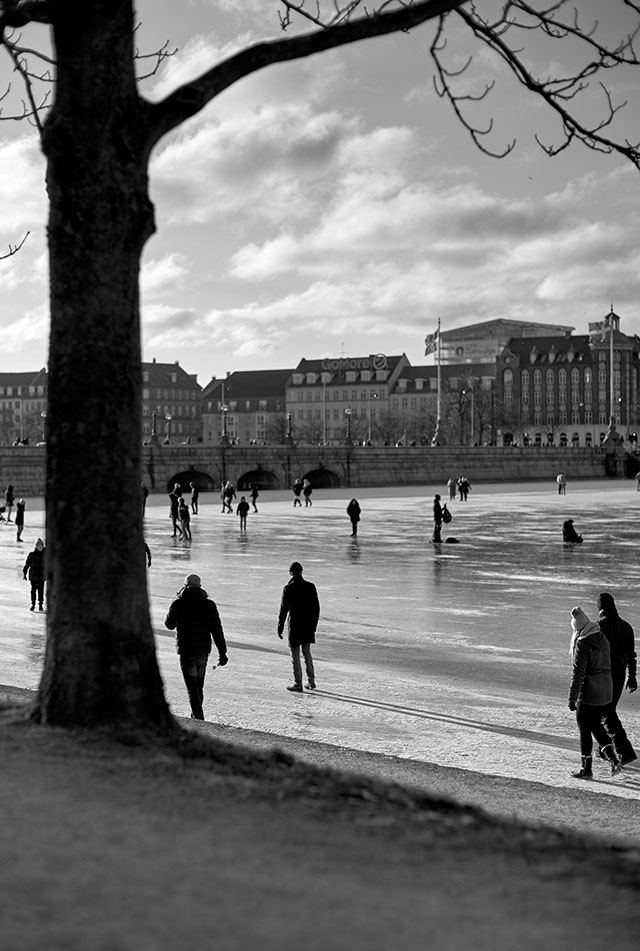 The citizens of Copenhagen like to take long walks around the big "Sortedams Sø" lakes in the center of Copenhagen. When it gets cold, the water freezes and becomes a paradise for ice skating, walking, bicycling across the ice, and selfies. 200 ISO. Leica 50mm Noctilux f/0.95. © Thorsten Overgaard.