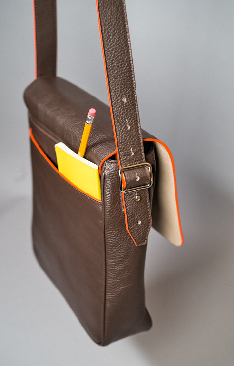 The pocket on the back can hold notebooks, passport, wallet or any other thing you want to keep handy, yet close to the body. 