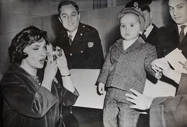 Gina Lollobrigida (1927-2023) was an Italian actress, international symbol of elegance – and a Leica photographer . Here in Rome Airport 1959 with her Leica, photographing her then 19 months old son Milko Skofic Jr. while waiting for his dad. She photographed Paul Newman, Salvador Dalí, Henry Kissinger, Audrey Hepburn, Ella Fitzgerald, and the German national football team, to name a few. © Associated Press. 