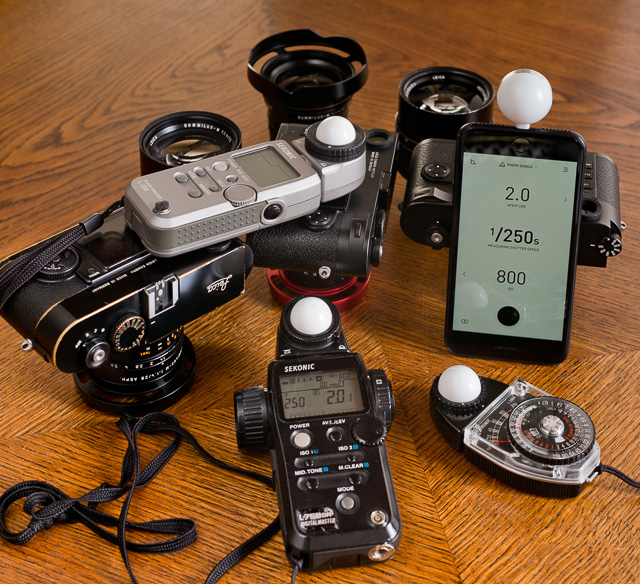 Some of the external light meters that exist. A good light meter is one that has a white bubble on it so you can measure the light in front of the subject (you hold the bubble where the subject is and the light meter reads how much light there is and calculates the shutter speed and aperture based on that - very precise!). © 2017 Thorsten Overgaard. See my article, "Using an external light meter for accurate, failproof metering" for more on external light meters. 