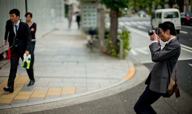 Yuta Kawasaki photographing in Tokyo. © 2015 Thorsten Overgaard.   