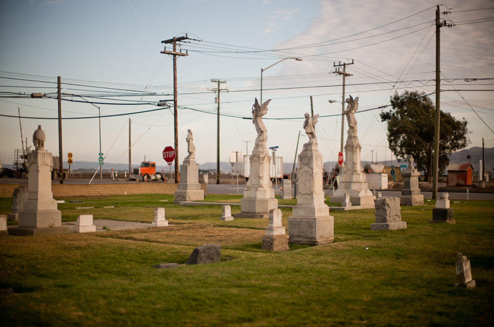 Crossroads: In a traffic crossing in City of Guadalupe in California, angels watching over the dead, electricity lines, telephone lines and trucks meet in a surreal symphony. Leica M 240 with Leica 50mm Noctilux-M ASPH f/0.95. Thorsten Overgaard © 2014.