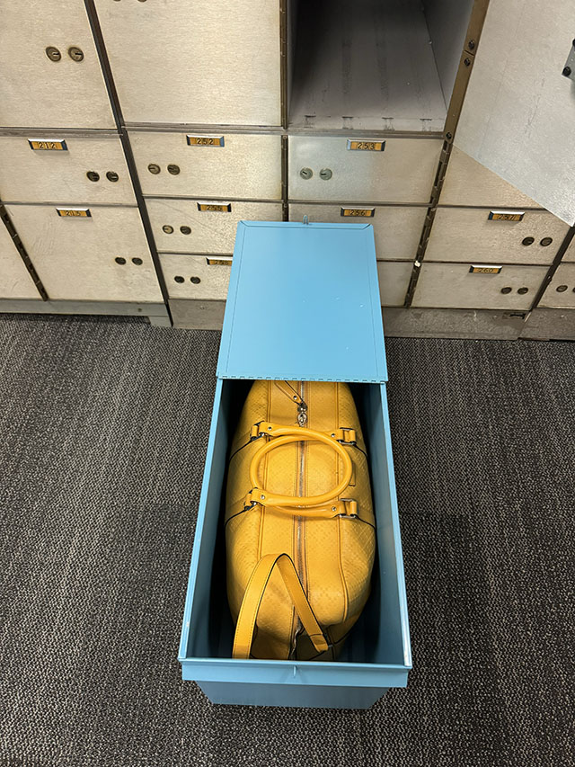 In 2024, ready to drop off my yellow backup bag with 100+ TB of hard drives into my $250-a-year bank box, I snapped this photo. This was before the anticipated Category 6 hurricane. No particular significance to the yellow Gucci bag other than that I had it, and it fits right inside the metal box for the bank box. Much easier to transport the drives in a bag and keep them in it. If it all burns down, at least I have my picture backup and a nice yellow weekend bag. © Thorsten Overgaard.