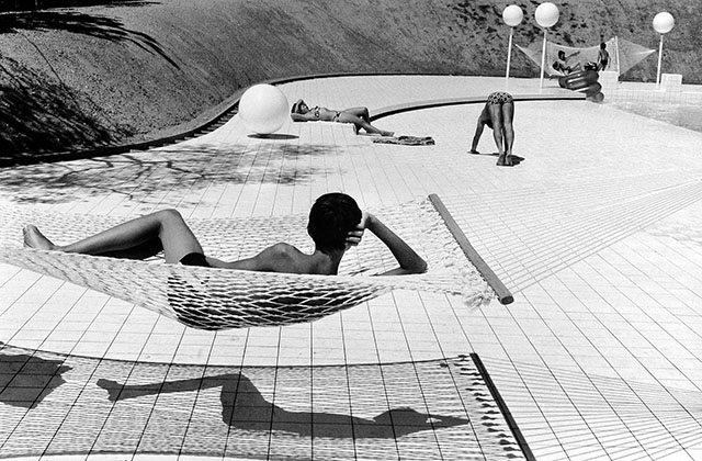 Martine Franch (1938-2012) made this photograph people by a swimming pool designed by Alain Capeilleres. She was discovering photography and the Leica in 1963 and met Henri Cartier-Bresson in 1966, whom she married. 