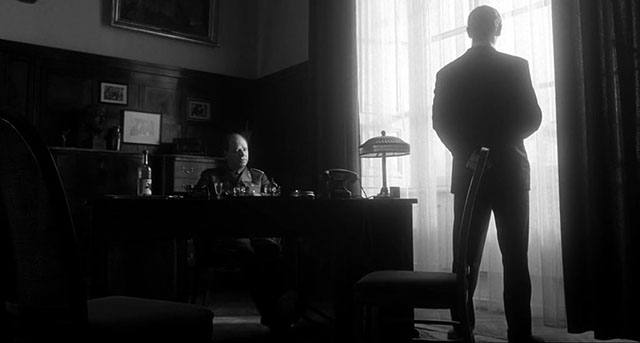 All this darkness, the magnificent position of the silhouette in the window ... and the usual slight overflow of light you often see in Spielberg scenes. Schindler's List (1993, directed by Steven Spielberg, cinematography by Janusz Kaminski).