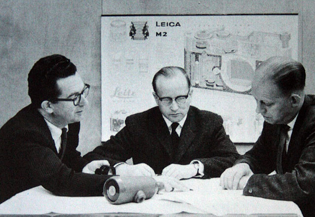 Dr. Walter Mandler (center) at the Ernst Leitz Camera factory. 