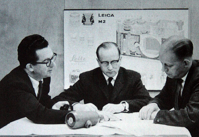 Dr. Walter Mandler (center) at the Ernst Leitz Camera factory.